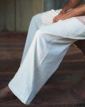Close-up of organic mulmul cotton pants while worn, showing the leg drape Close-up of organic mulmul cotton pants while worn, showing the leg drape