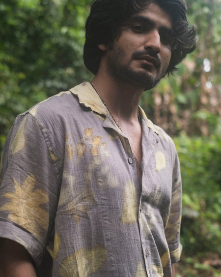 Man wearing hand-dyed Hibiscus Heroes shirt made with natural plant dyes in Auroville, India