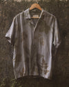Botanical Shirt in charcoal gray hanging outdoors, eco printed with foraged leaves on natural cambric cotton.