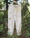 Botanical Pants in natural slub cotton hanging outdoors, eco printed with foraged leaves and dyed with sappan wood.