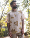Model wearing a natural white botanical t-shirt outdoors, front view