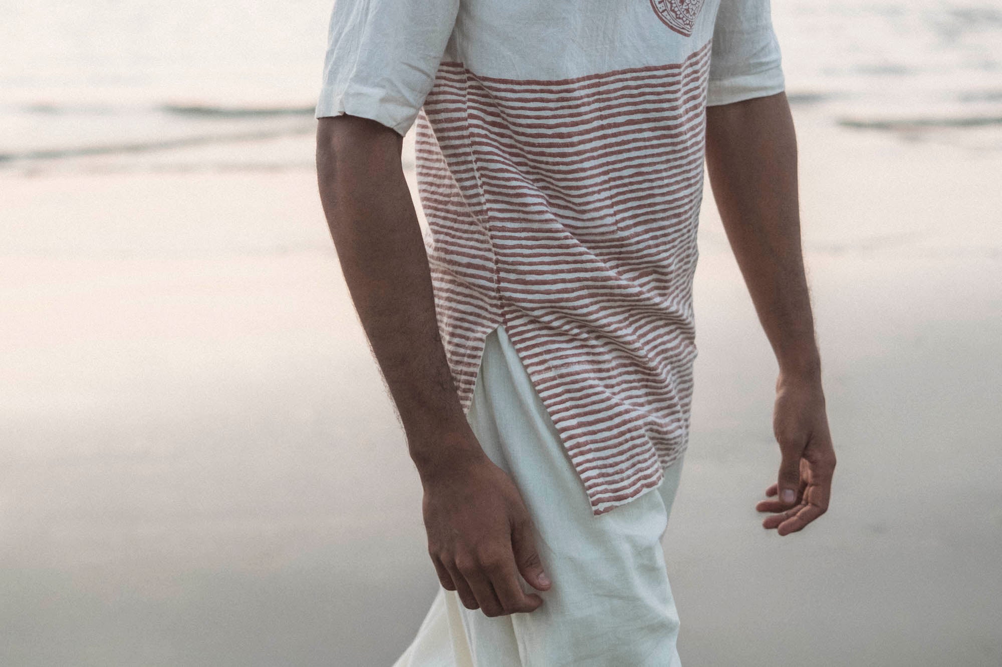 Close-up of an organic mulmul cotton kurta with a rust striped panel, styled with organic mulmul cotton pants